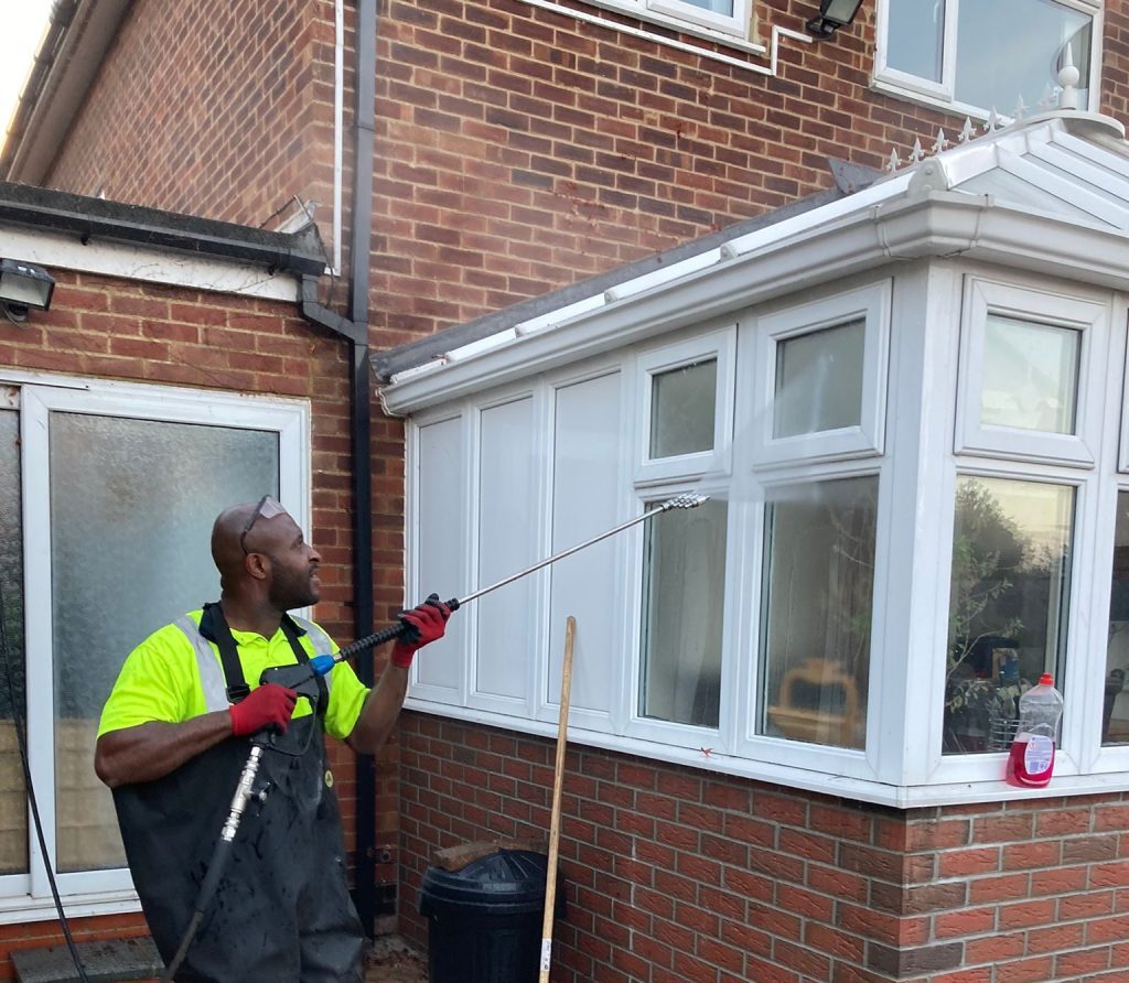 Amara from ADC Pressure Washing cleaning a house exterior