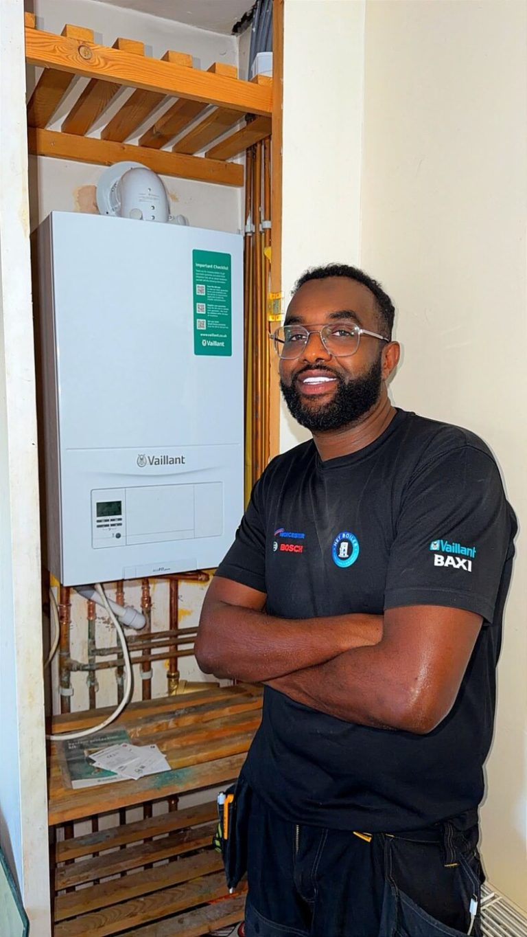 Ahmed from Hey Boiler beside a Vaillant boiler